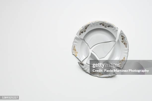 broken white plate on white background - household equipment stock pictures, royalty-free photos & images