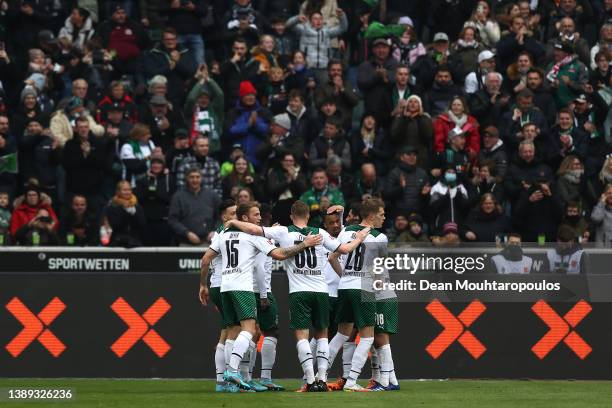 Breel Embolo of Borussia Monchengladbach celebrates with teammates after scoring their side's first goal during the Bundesliga match between Borussia...