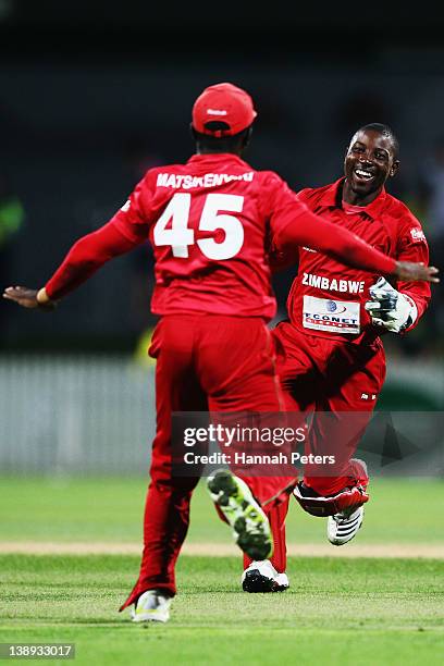 Tatenda Taibu celebrates with Stuart Matsikenyeri of Zimbabwe after running James Franklin out New Zealand during the second International Twenty20...