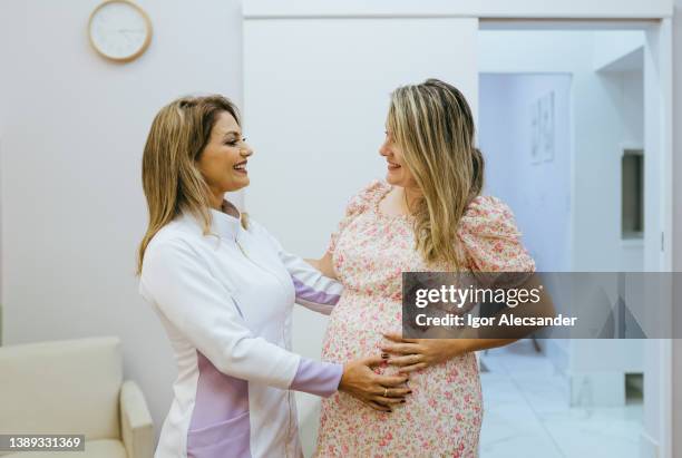 portrait of pregnant woman and obstetrician nurse - mid wife stock pictures, royalty-free photos & images