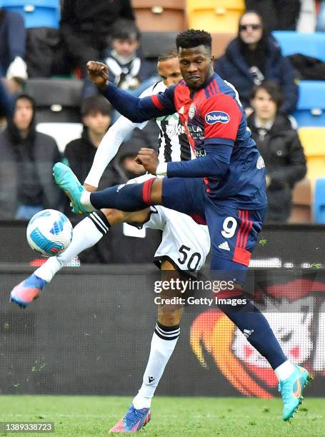 Keita Balde of Cagliari Calcio competes for the ball with Rodrigo Becao of Udinese Calcio during the Serie A match between Udinese Calcio and...