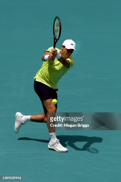 Casper Ruud of Norway returns a shot to Carlos Alcaraz of Spain in the men's singles final on day 13 of the Miami Open at Hard Rock Stadium on April...