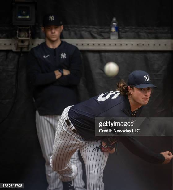 New York Yankees' pitcher Gerrit Cole throwing in the bullpen with pitching coach Matt Blake watching at practice during spring training at George E....