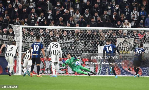 Wojciech Szczęsny of Juventus dives in vain as Hakan Calhanoglu of FC Internazionale scores their sides first goal from the penalty spot during the...