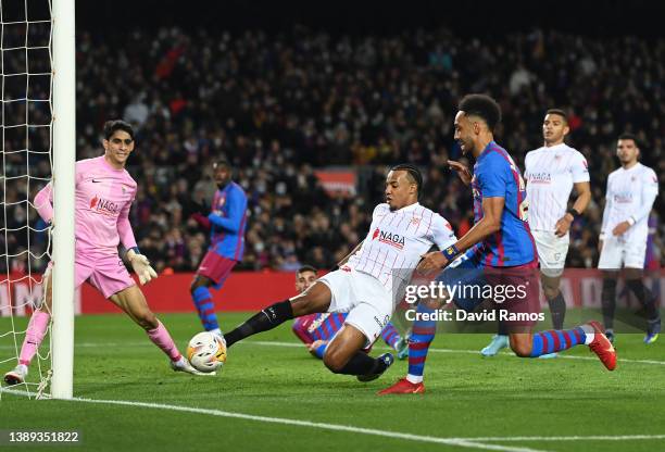 Jules Kounde of Sevilla battles for possession with Pierre-Emerick Aubameyang of FC Barcelona during the LaLiga Santander match between FC Barcelona...