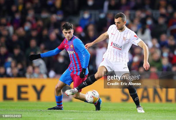 Joan Jordan of Sevilla battles for possession with Pedri of FC Barcelona during the LaLiga Santander match between FC Barcelona and Sevilla FC at...