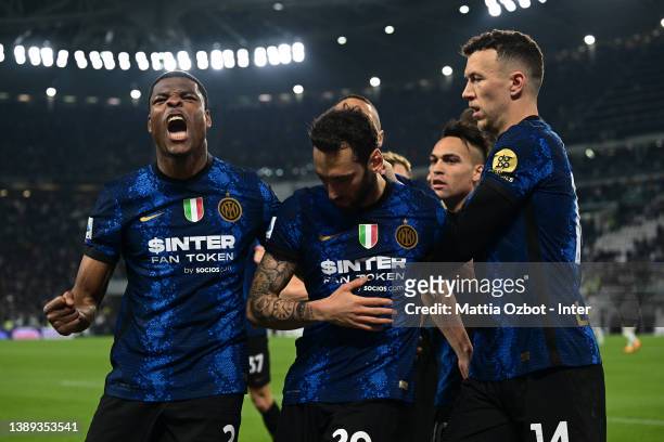 Hakan Calhanoglu of FC Internazionale celebrates with team-mates after scoring the opening goal during the Serie A match between Juventus and FC...