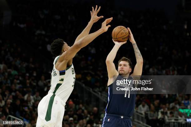 Luka Doncic of the Dallas Mavericks shoots a jump shot over the reach of Giannis Antetokounmpo of the Milwaukee Bucks during the second half of a...