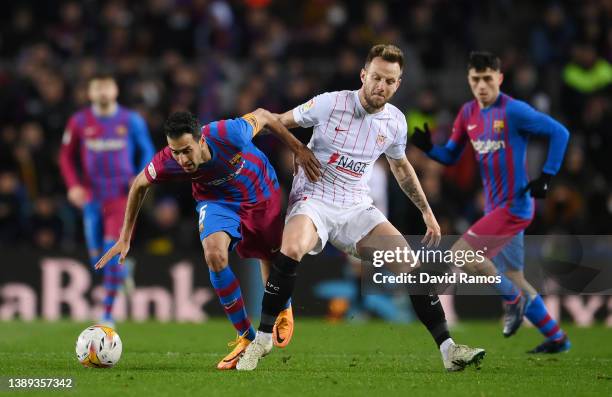 Sergio Busquets of FC Barcelona is tackled by Ivan Rakitic of Sevilla during the LaLiga Santander match between FC Barcelona and Sevilla FC at Camp...