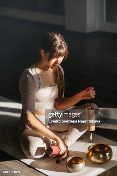 girl practices yoga in the studio - gong stock pictures, royalty-free photos & images