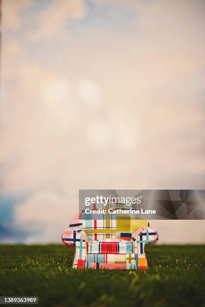 a cute patchwork sofa in grass under a cloudy sky - patchwork stock pictures, royalty-free photos & images