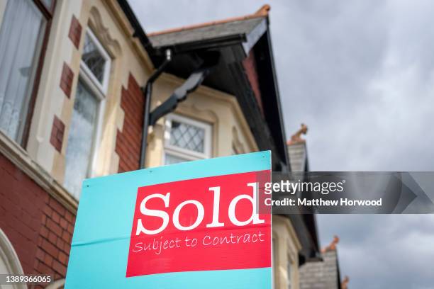 Sign in front of a property which says "sold subject to contract" on a residential street on April 2, 2022 in Cardiff, Wales.