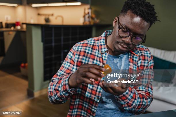 young man taking medicine - anti depressant stock pictures, royalty-free photos & images