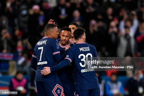 Neymar Jr of Paris Saint-Germain is congratulated by teammates Kylian Mbappe and Leo Messi after scoring during the Ligue 1 Uber Eats match between...