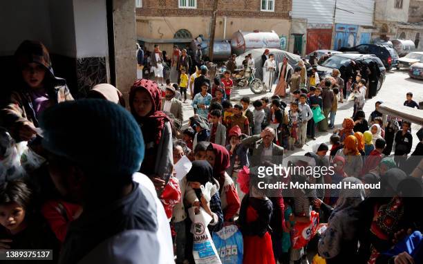 People affected by war receive free meals provided by a charitable kitchen in the Mseek area on April 03, 2022 in Sana'a, Yemen. A two-month...