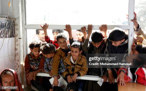 Children affected by war line up to receive free meals provided by a charitable kitchen in the Mseek area on April 03, 2022 in Sana'a, Yemen. A...