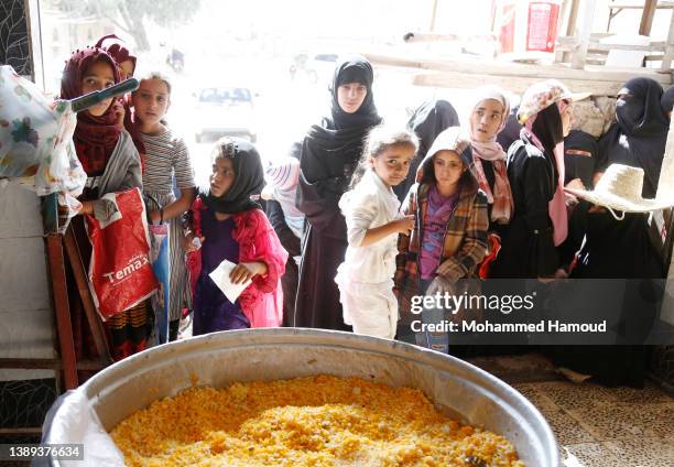 People affected by war wait to receive free meals provided by a charitable kitchen in the Mseek area on April 03, 2022 in Sana'a, Yemen. A two-month...