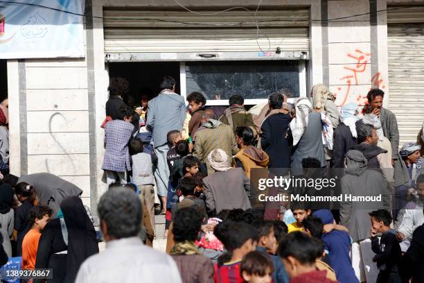 People affected by war receive free meals provided by a charitable kitchen in the Mseek area on April 03, 2022 in Sana'a, Yemen. A two-month...