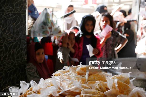 Girls affected by war wait to receive free meals provided by a charitable kitchen in the Mseek area on April 03, 2022 in Sana'a, Yemen. A two-month...