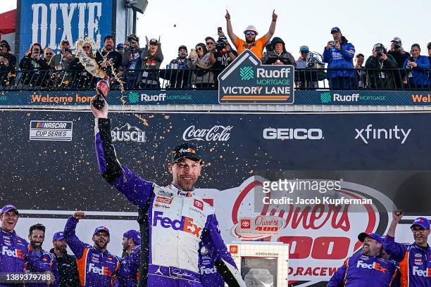 Denny Hamlin, driver of the FedEx Express Toyota, celebrates in the Ruoff Mortgage victory lane after winning the NASCAR Cup Series Toyota Owners 400...