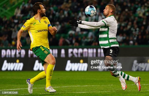 Islam Slimani of Sporting CP with Marco Baixinho of FC Pacos de Ferreira in action during the Liga Bwin match between Sporting CP and FC Pacos de...