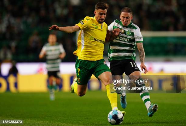 Helder Ferreira of FC Pacos de Ferreira with Nuno Santos of Sporting CP in action during the Liga Bwin match between Sporting CP and FC Pacos de...