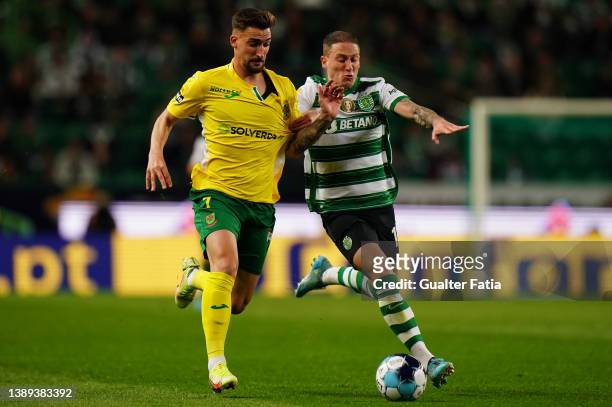 Helder Ferreira of FC Pacos de Ferreira with Nuno Santos of Sporting CP in action during the Liga Bwin match between Sporting CP and FC Pacos de...