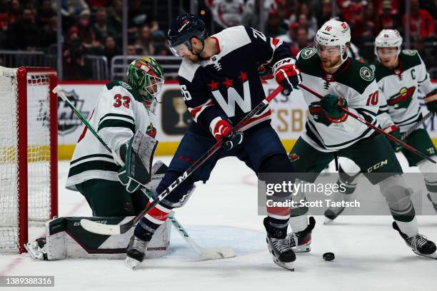 Cam Talbot of the Minnesota Wild makes a save in front of Nic Dowd of the Washington Capitals during the second period at Capital One Arena on April...