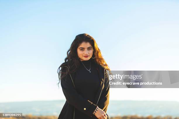 vivid light mexican american golden hour winter evening sunset hike afro-latinx lifestyle in the us alone time in western colorado teenage female of latinx ethnicity relaxing outdoors 4k video series - mexican american stock pictures, royalty-free photos & images