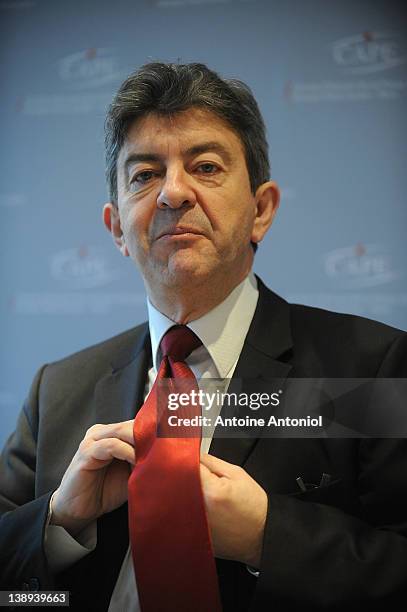 Front De Gauche' Candidate Jean-Luc Melenchon adjusts his tie during a press conference at Centre d'Accueil de la Presse Etrangere on February 14,...