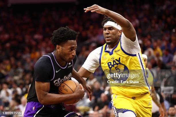 Damian Jones of the Sacramento Kings is guarded by Kevon Looney of the Golden State Warriors in the first half at Golden 1 Center on April 03, 2022...