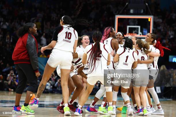 Kamilla Cardoso, Aliyah Boston of the South Carolina Gamecocks, and Victaria Saxton of the South Carolina Gamecocks celebrate with teammates after...