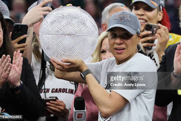 Head coach Dawn Staley of the South Carolina Gamecocks poses with the Invesco QQQ WBCA Coaches’ Trophy after defeating the UConn Huskies 64-49 during...