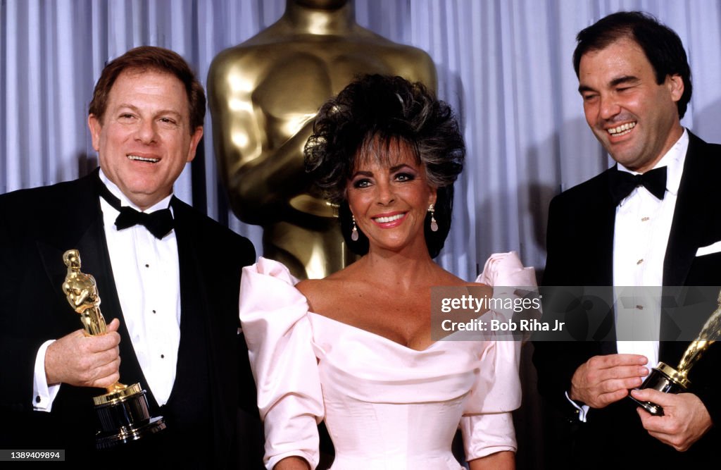 Elizabeth Taylor with Oliver Stone and Arnold Kopelson Best Picture at Academy Awards Show 1987