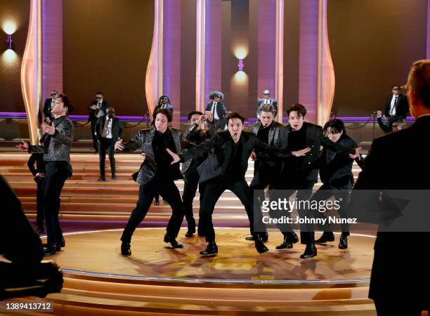 Jimin, Jin, V, J-Hope, RM, Jungkook, and Suga of BTS perform onstage during the 64th Annual GRAMMY Awards at MGM Grand Garden Arena on April 03, 2022...