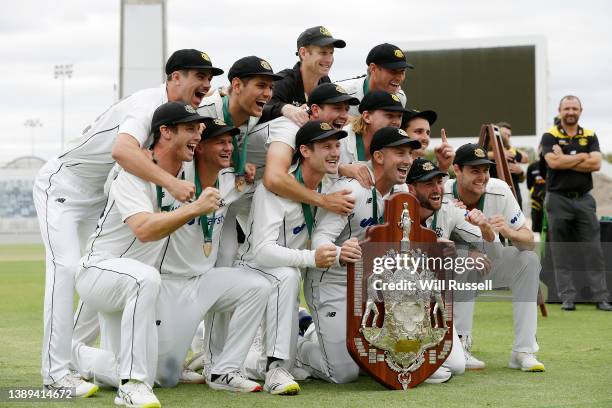 Shaun Marsh of Western Australia celebrates with the team and the Sheffield Shield after defeating Victoria during day five of the Sheffield Shield...