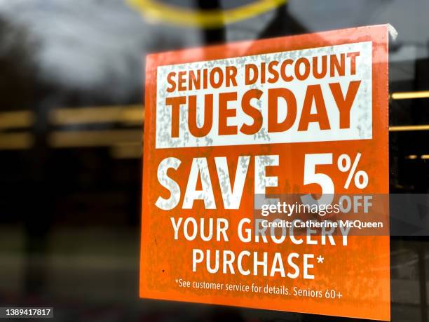 senior citizen discount grocery store window sign - coupons stock pictures, royalty-free photos & images