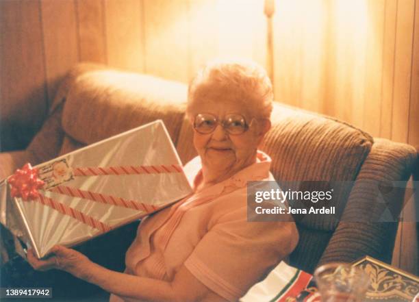 happy grandmother christmas present vintage old family photo 1980s 1990s - christmas atmosphere stock pictures, royalty-free photos & images