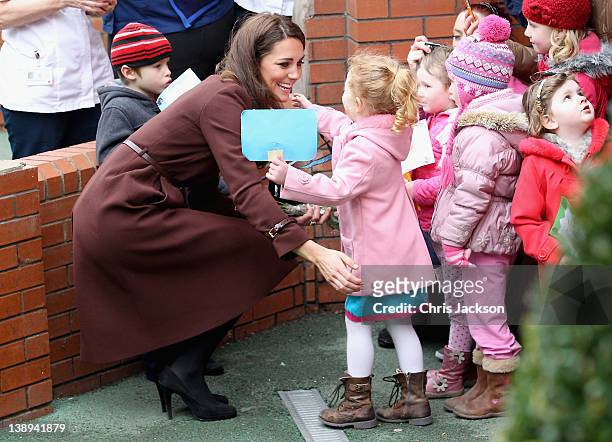 Catherine, Duchess of Cambridge hugs a young girl as she visits Alder Hey Children's NHS Foundation Trust on February 14, 2012 in Liverpool, England....