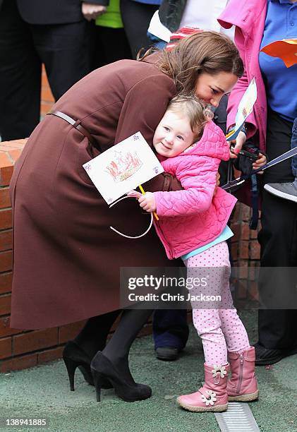 Catherine, Duchess of Cambridge hugs a young girl as she visits Alder Hey Children's NHS Foundation Trust on February 14, 2012 in Liverpool, England....