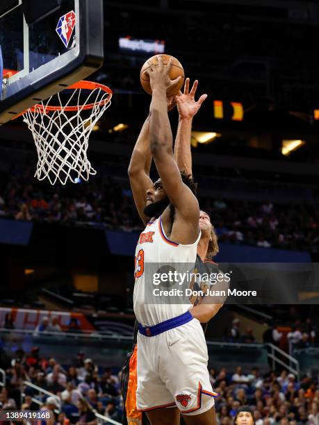 Center Mitchell Robinson of the New York Knicks dunks the ball against center Robin Lopez of the Orlando Magic during first half of the game at the...