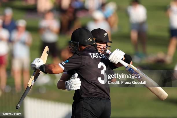 Will Young of New Zealand celebrates 100 runs with Ross Taylor during the third and final one-day international cricket match between the New Zealand...