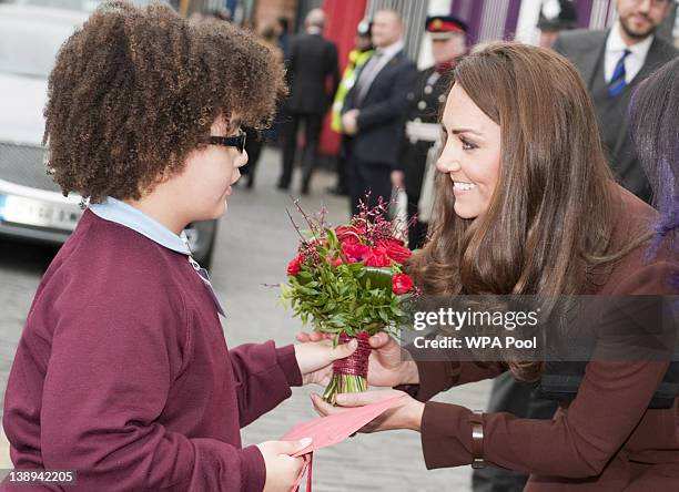 Eight-year-old Jaqson Johnston-Lynch presents Catherine, Duchess of Cambridge a posey of red roses and Valentine's Day present after her visit to...