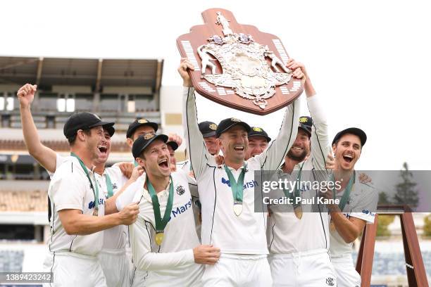 Shaun Marsh of Western Australia holds the Sheffield Shield aloft after winning on day five of the Sheffield Shield Final match between Western...