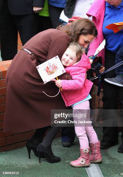 Catherine, Duchess of Cambridge hugs Nancy Williams, aged 3, as she visits Alder Hey Children's NHS Foundation Trust on February 14, 2012 in...