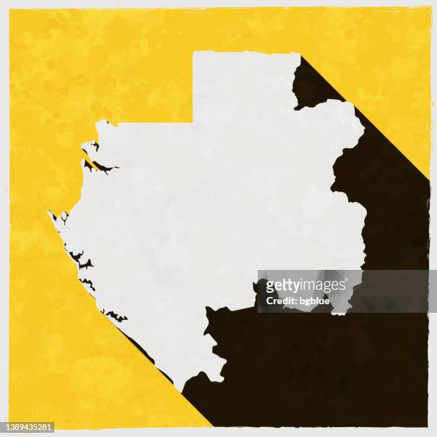 gabon map with long shadow on textured yellow background - libreville gabon stock illustrations