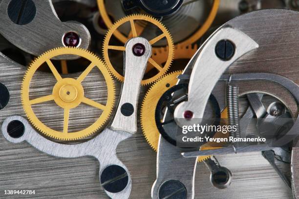 clock mechanism with gears, close-up. - uhrwerk stock-fotos und bilder