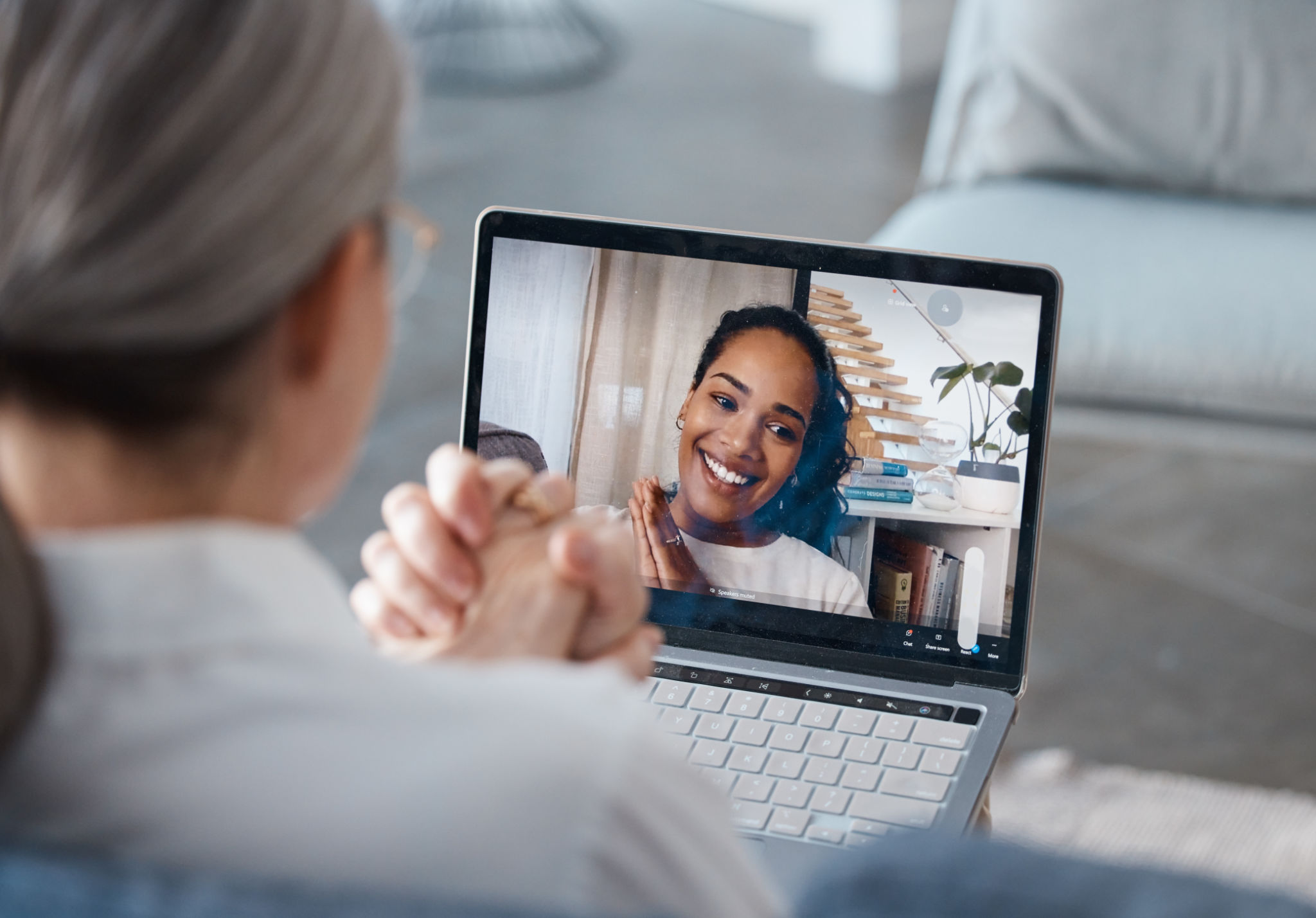 Shot of an unrecognisable psychologist sitting and using a laptop for an online consultation with her patient Shot of an unrecognisable psychologist sitting and using a laptop for an online consultation with her patient