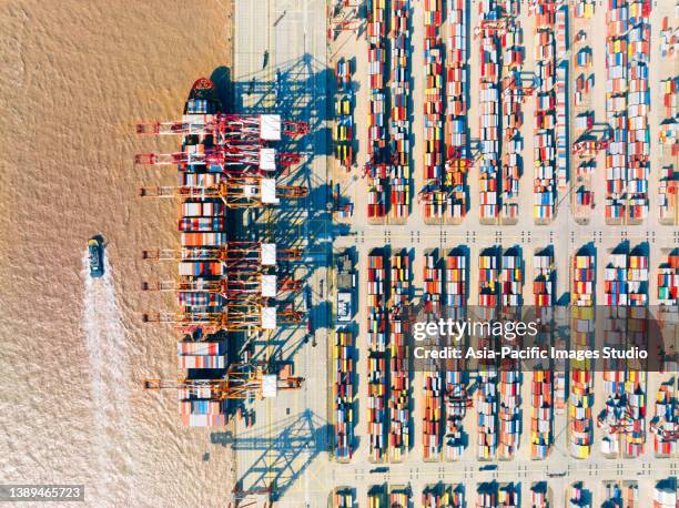 aerial view container ship in port at container terminal port in yangshan port, shanghai - docklands studio stock pictures, royalty-free photos & images