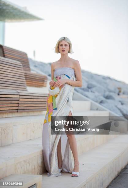 Lisa Hahnbück is seen wearing Fendi dress with graphic print, bag Fendi, Amina Muaddi heels in white on April 02, 2022 in Dubai, United Arab Emirates.